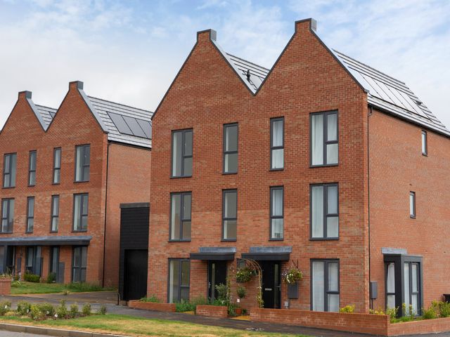 Two brick houses with solar panels and gardens at Peak Avenue Retreat in Wingerworth near Chesterfield