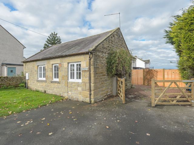 A house with a gate and garden area at The Forge in Morpeth