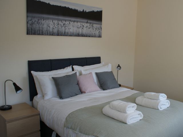 A bedroom with a bed and towels on top at The Newborough Apartment 5 in Scarborough