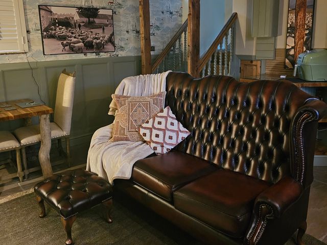 A living room with a sofa and dining table in Driftwood Bridlington