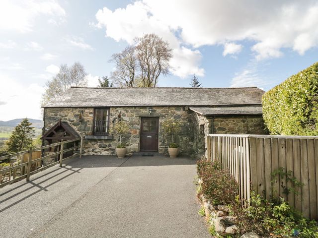 A stone building with a door and windows at Cyffdy Cottage - Arenig in Bala