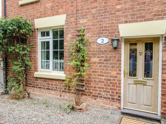 An entrance with a door and window at 2 Aqueduct Cottages Chirk Bank near Chirk