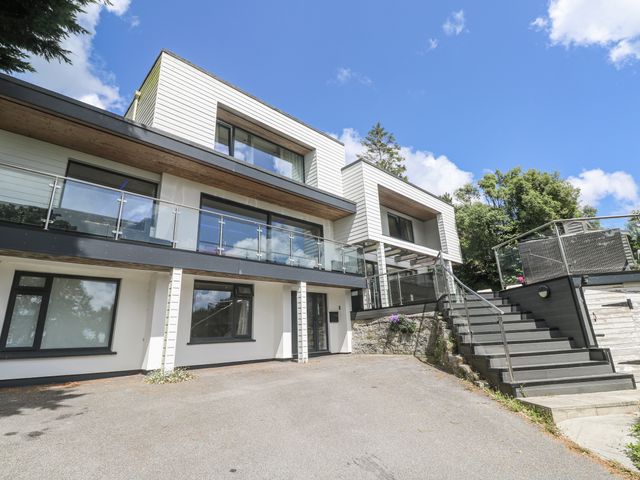 A modern house exterior with a balcony and steps at Treliance in Truro