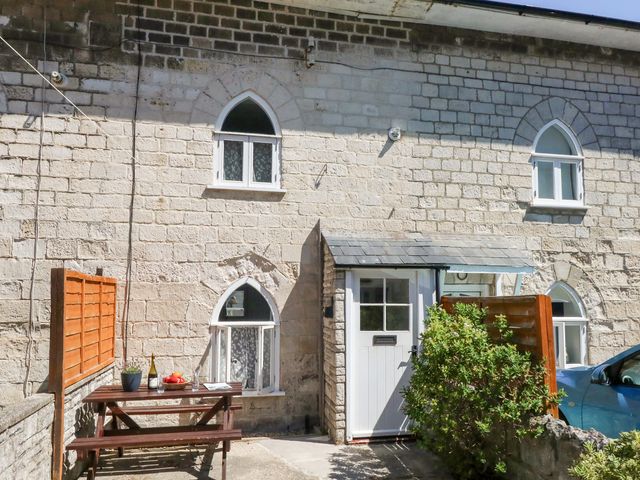 An outdoor view of a house with a table and chairs at Driftwood in Weymouth
