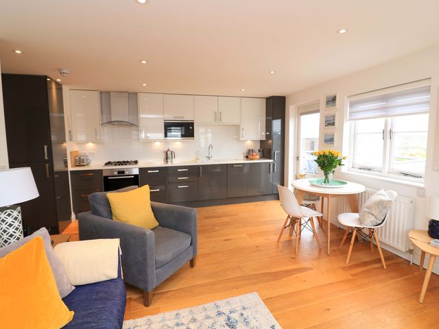 A kitchen with a sofa and dining area at 61B Fore Street in Kingsbridge
