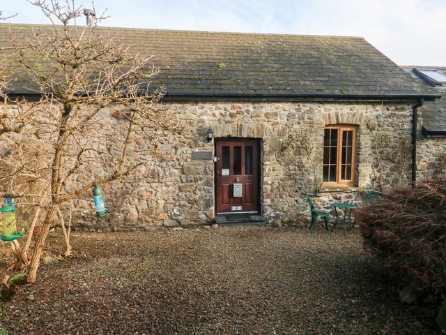 A stone cottage exterior with a door and windows at 8 Rogeston Cottages Haverfordwest