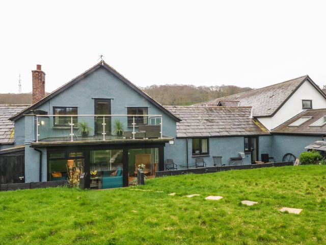 A house with a balcony and garden area at Pen Glorian in Conwy