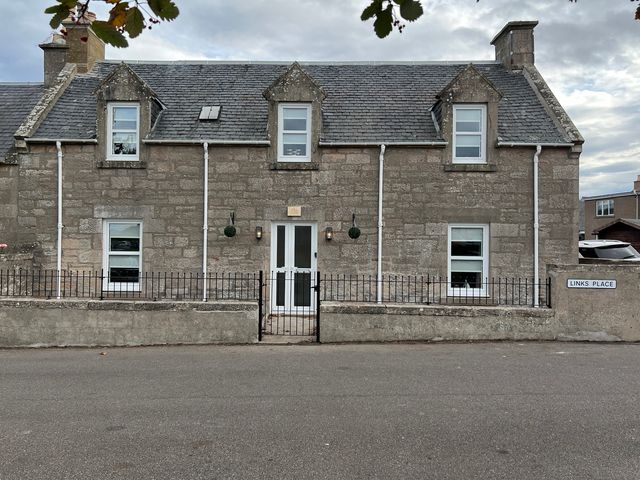 A house with windows and a door at 1 Links Place in Nairn