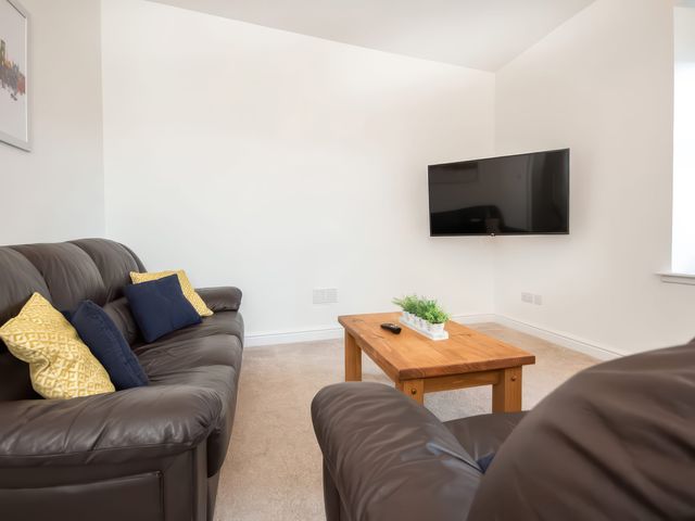 A living room with a sofa and coffee table at 4 Lower Kessock Street in Inverness