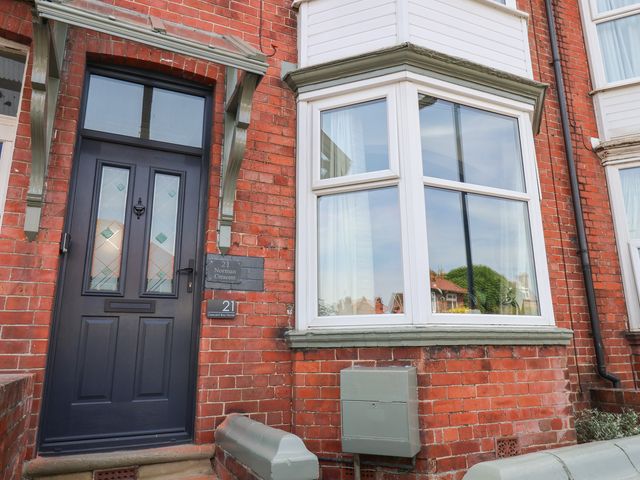 A front door and window at Crescent Bay House