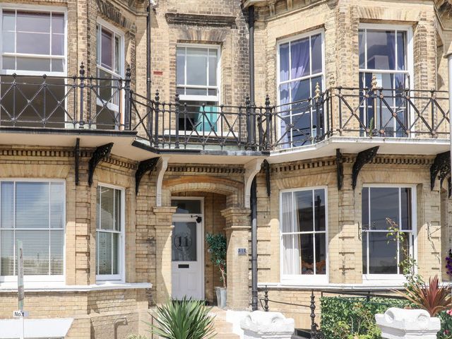 An outdoor view of a brick house with a balcony at The Overlook in Kirkley near Lowestoft