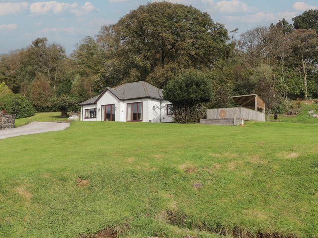 A house with yard and deck at The Lodge in Bridgend