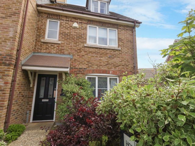 A house with plants in the front at Farthings in Weymouth