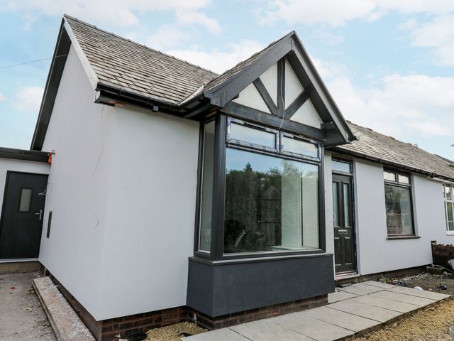 An exterior view of a house with a pathway at 489 New Hey Road Huddersfield