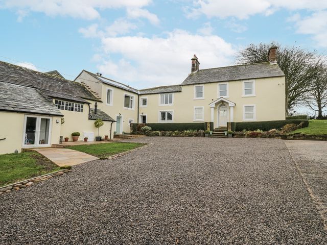A house with a driveway and garden at Swift Barn in Wigton