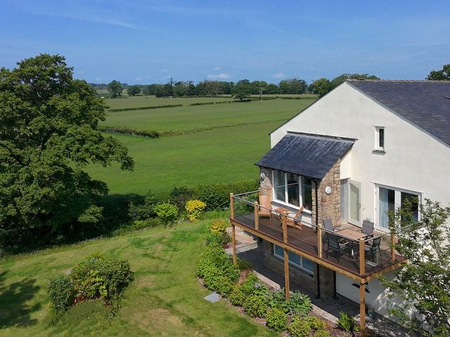 A house with a deck and garden at High View Meadows in Kirkby Lonsdale