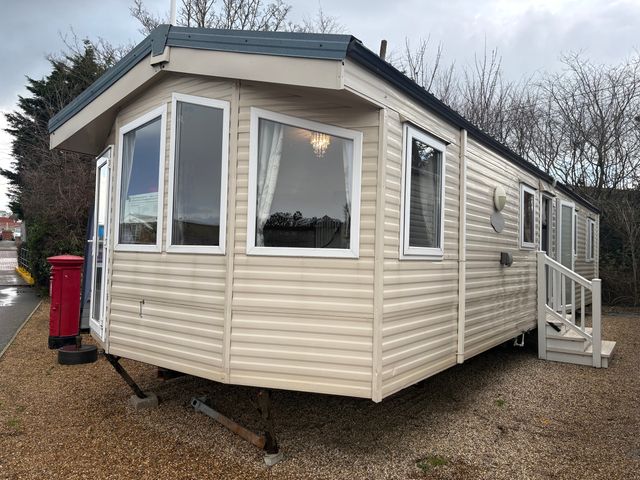 A caravan with windows and a door at Caravan 941 in Clacton-On-Sea