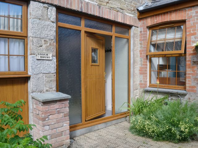 An entrance with a door and windows at The Coach House in Budock Water near Falmouth