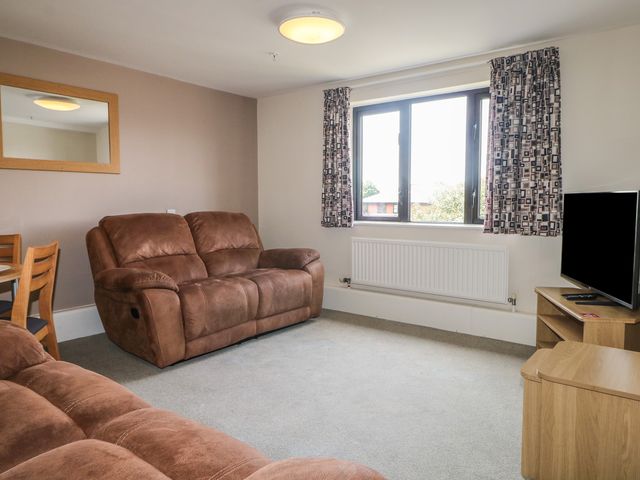 A living room with a sofa and television at Flat 2 in Littlehampton