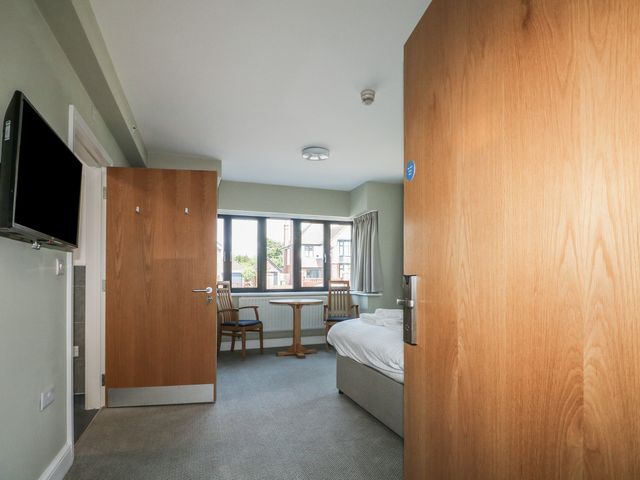 A bedroom with a table and chairs at Bedroom 2 in Littlehampton