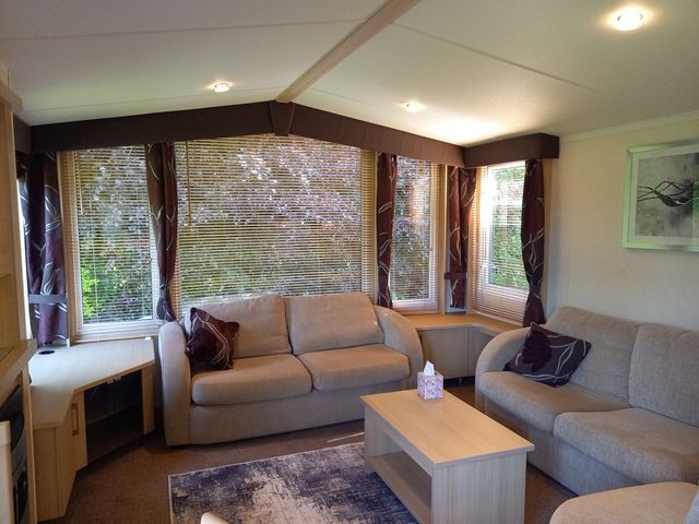 A living room with sofas and a coffee table at Emma No.6 in Llandegfan