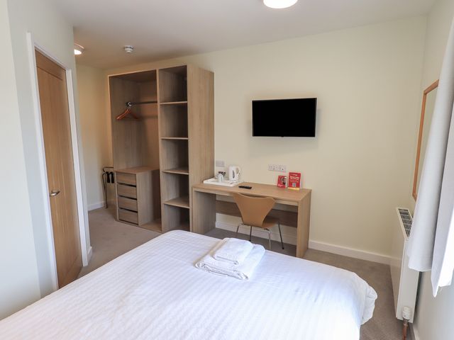 A bedroom with a bed and desk at Bedroom 2 in Penrith