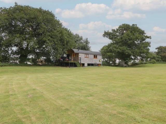 A shepherd hut surrounded by grass and trees at Shepherd Hut’s Bristol