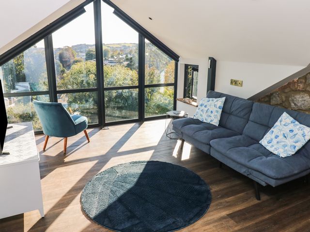 A living room with a sofa and armchair at 10 Brython Place Tenby