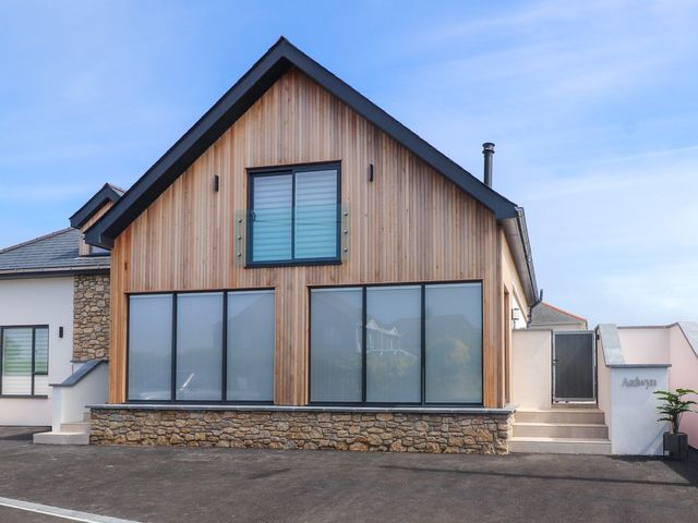 A house with large windows and a stone facade at Ardwyn Rhosneigr
