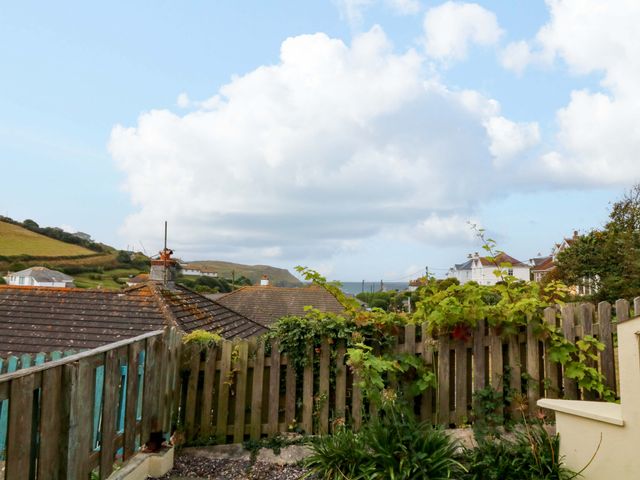An outdoor view of rooftops and hills at Surf View in Hope Cove