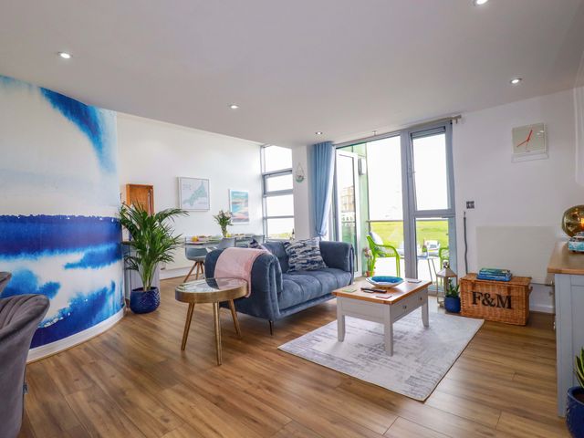 A living room with a sofa and coffee table at Penthouse @46Zinc - Headland View in Newquay
