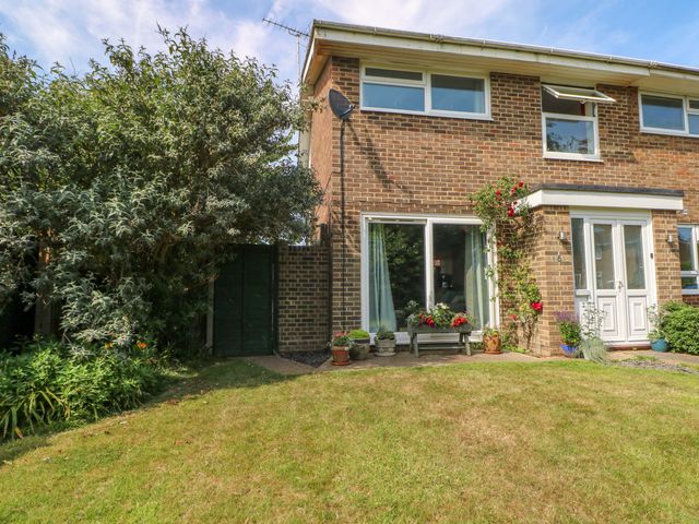 An outdoor view of a house with garden features at 6 Ashton Gardens, Rustington