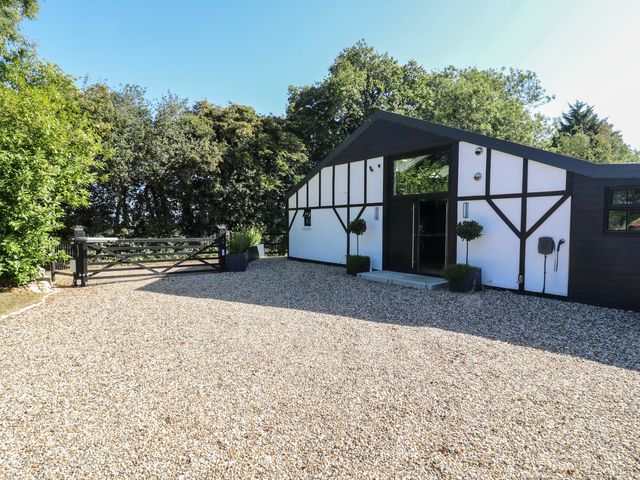 An entrance view of a house with a gravel driveway at The Old Workshop Wormshill near Harrietsham