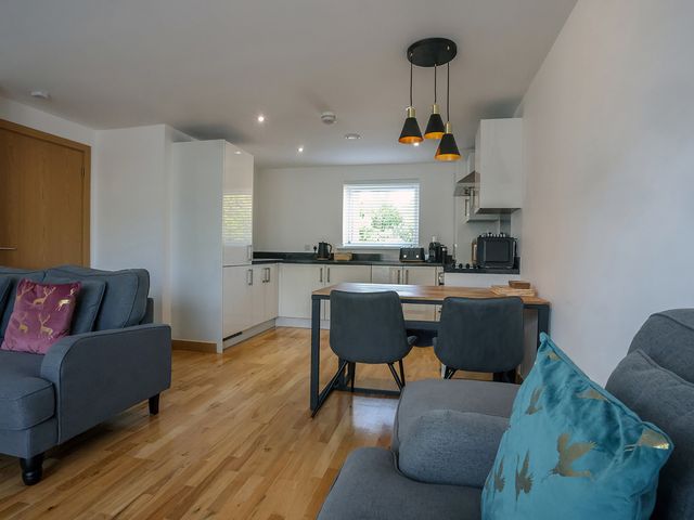 A kitchen with dining table and chairs at Whitstable Bay Getaway in Whitstable
