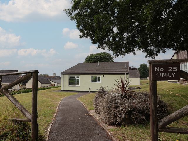 A bungalow with pathway and sign at Harcombe House Bungalow 25 Chudleigh