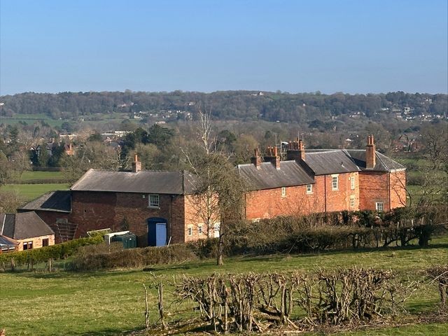 A brick building with a garden and a landscape view at Farnah House Barn in Duffield
