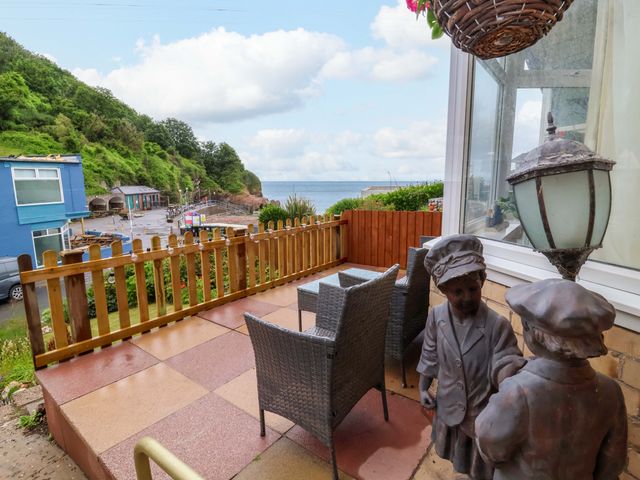 An outdoor patio with chairs and a table at Zide the Zea in Hele Bay, Ilfracombe