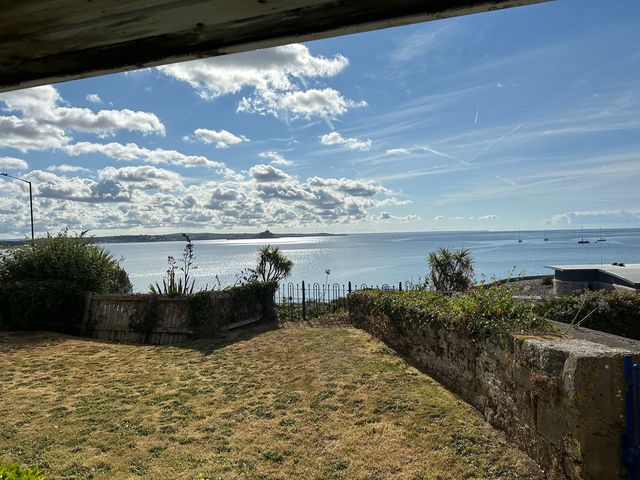 A view of the sea and clouds from a garden at 1 Penrose Court in Penzance