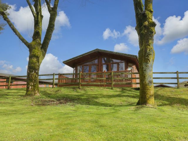 A cabin with deck and trees at Wansfell 2 Limefitt Park near Troutbeck