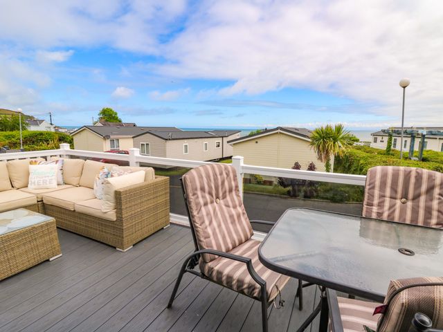 An outdoor seating area with sofa and table at Ty Seren in New Quay