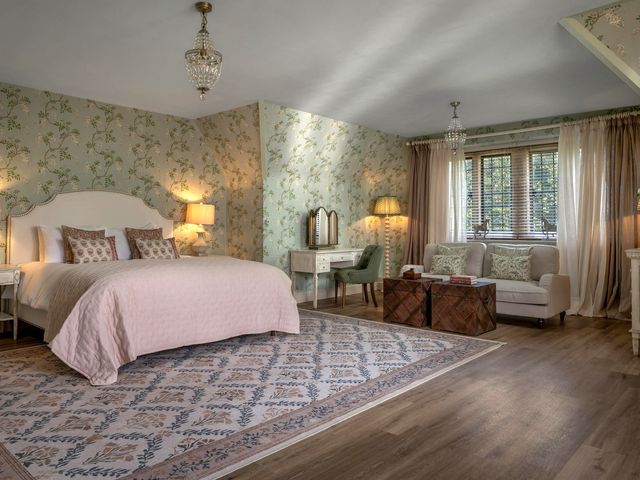 A bedroom with a bed and seating area at Whistler Rooms
