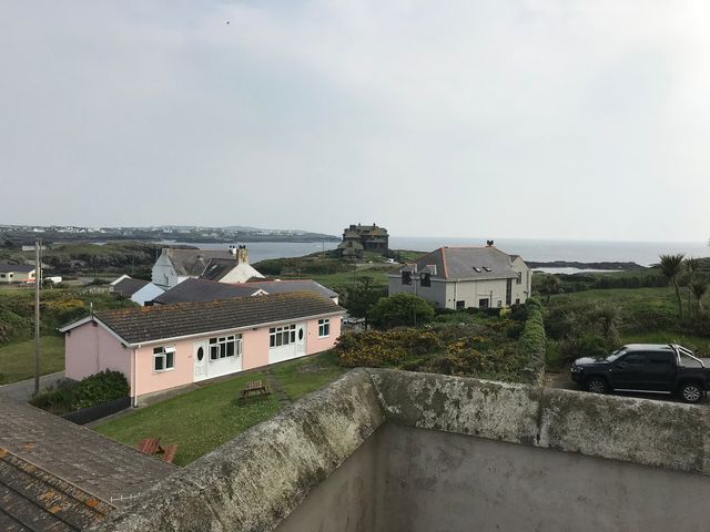 A view of houses and the ocean at Sea Views No 8 Plas Darien in Trearddur Bay