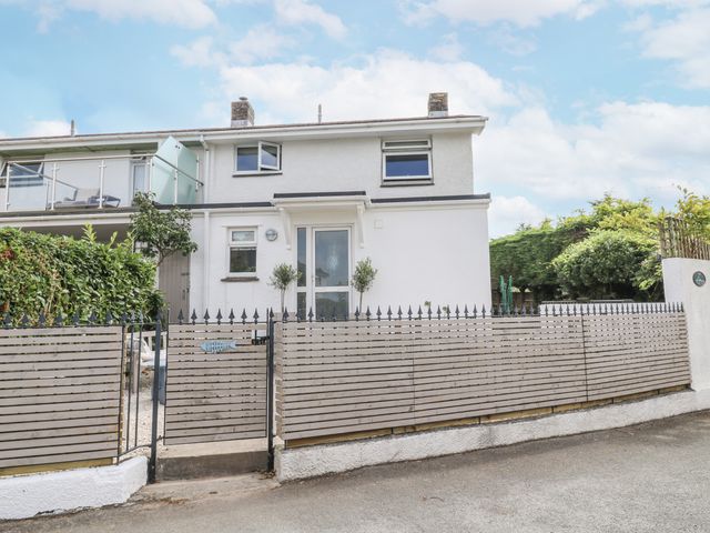 A house with a fence and door at 1 Island View in Thurlestone