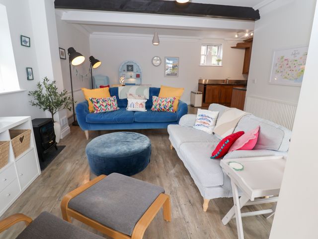 A living room with a blue sofa and decorative items at Old Felixstowe, Bath Road, Felixstowe, Suffolk