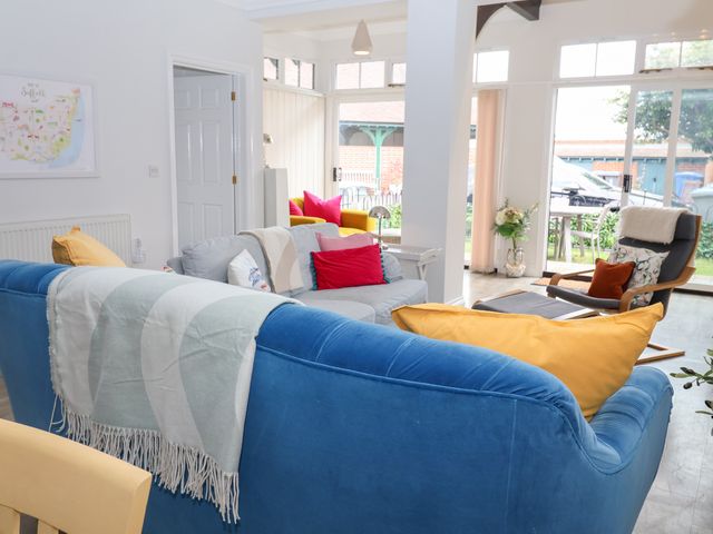 A living room with a sofa and cushions at Old Felixstowe, Bath Road in Felixstowe, Suffolk