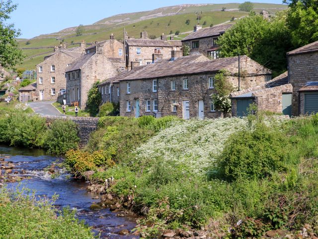 A rural scene with stone houses beside a stream at The Old Dairy in Richmond