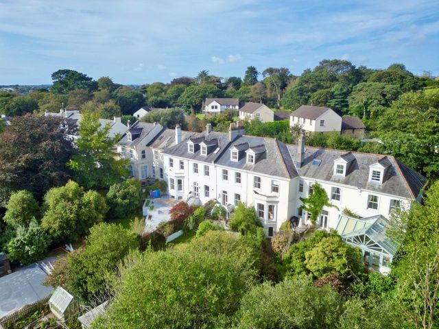 An outdoor view of a house with a garden at Trenare in Truro