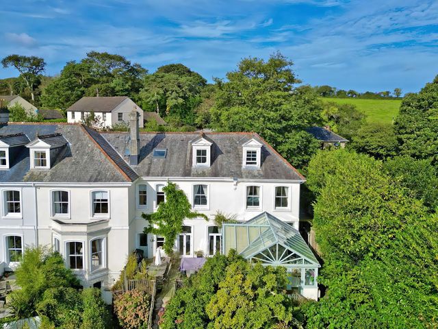 An exterior view of a house with greenhouse and garden at Trenare in Truro