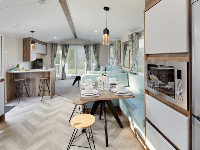 A living room with a table set for dining at Island Breeze - Hayling Island