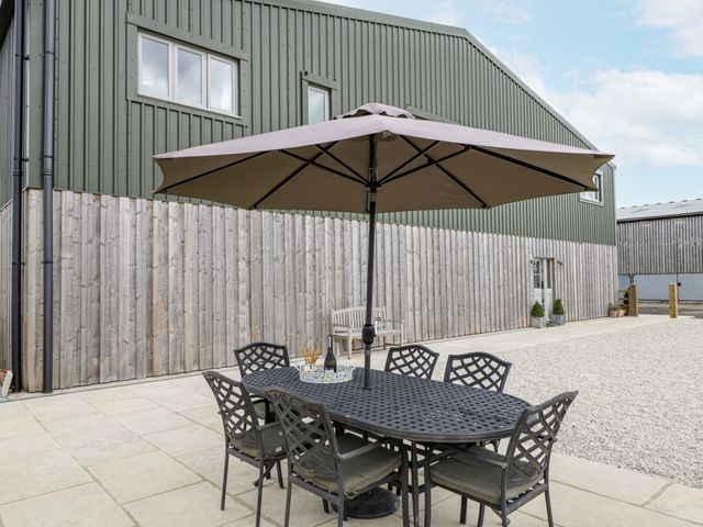 An outdoor seating area with a table and chairs at Hayloft